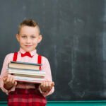 boy-blackboard-with-books-stack